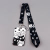 A black and white cartoon cat card holder lanyard with a patterned strap and clear plastic card holder.