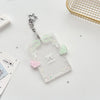 Clear acrylic card holder with a decorative bow and stars attached to a silver keychain.