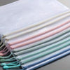 A stack of mesh zipper bags in various pastel colors, including pink, mint green, and light blue.