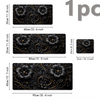 A set of three floral design mouse pads in black and gold accents, showing different sizes.