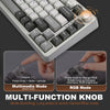 A close-up view of a white mechanical keyboard showing multimedia and RGB mode functions.
