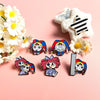 A set of five metal cartoon anime brooches featuring characters with colorful hair and distinct facial expressions.