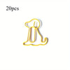 A yellow paper clip shaped like a sitting dog, part of a 20-pack desk organizer.