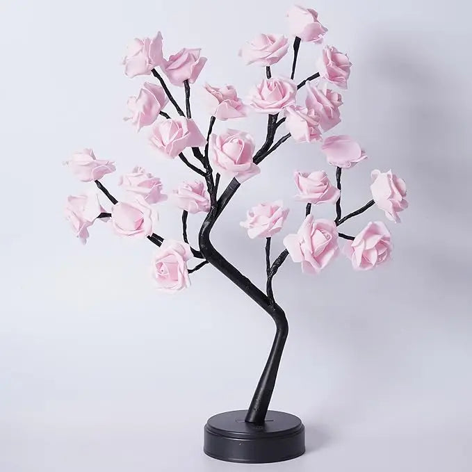A black rose tree with pink artificial roses used as an LED night light.