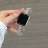 A hand is holding a black smartwatch with a crystal-embellished silver watch strap featuring sparkling zircon accents.