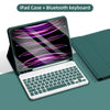 A green iPad case with a Bluetooth keyboard is shown open, displaying a colorful trackpad interface.