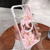 A hand holds a clear pink lily floral transparent iPhone case with a shockproof bumper.