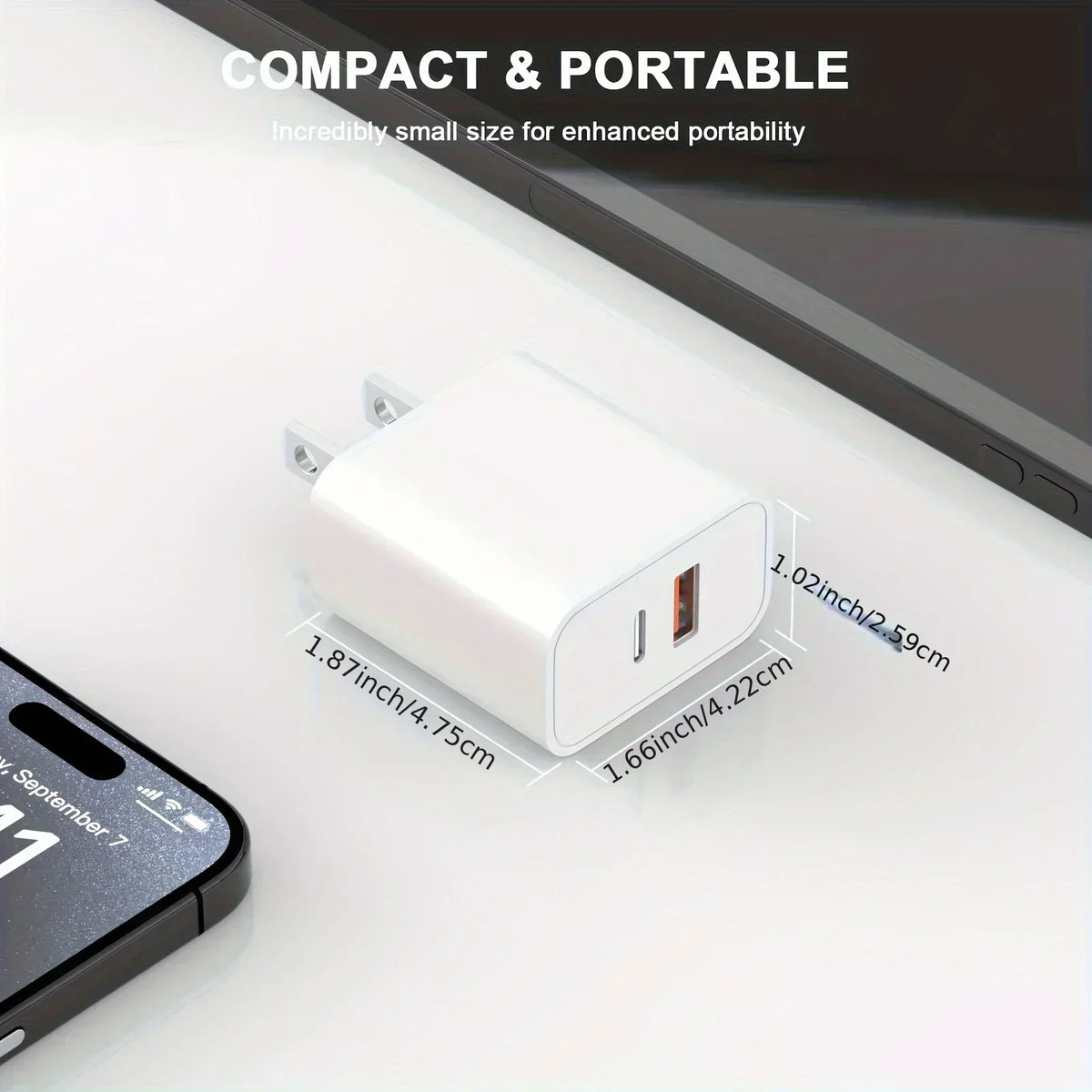A white compact dual port USB-C fast charger with a Lightning cable is shown on a white surface.