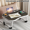 A foldable laptop desk organizer tray with a wooden surface and metal stand placed on a bed.