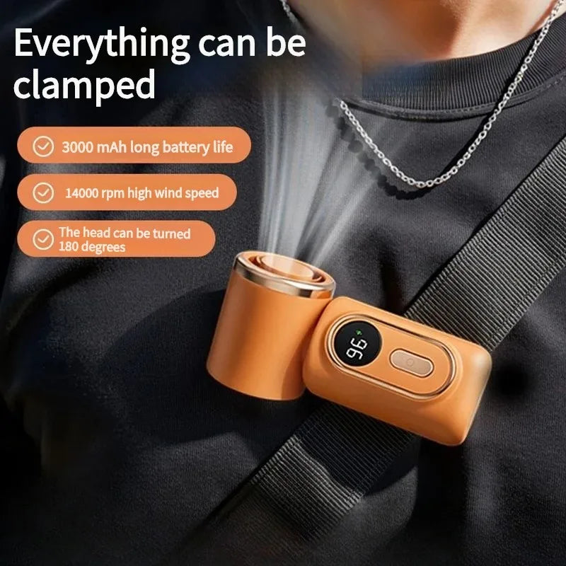 A person is holding a portable clip-on handheld cooling fan with an orange casing and a silver chain.