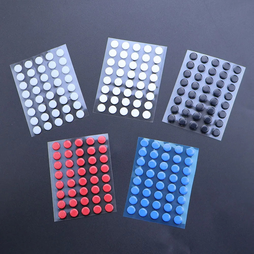 Four packs of universal mouse skates in various colors including white, gray, and red on a dark surface.