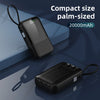Batterie portable noire compacte de la taille d'une paume avec indicateur de batterie et câble.
