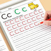 A child's hand traces the letter Cc on a workbook page with red pencil lines for tracing practice.