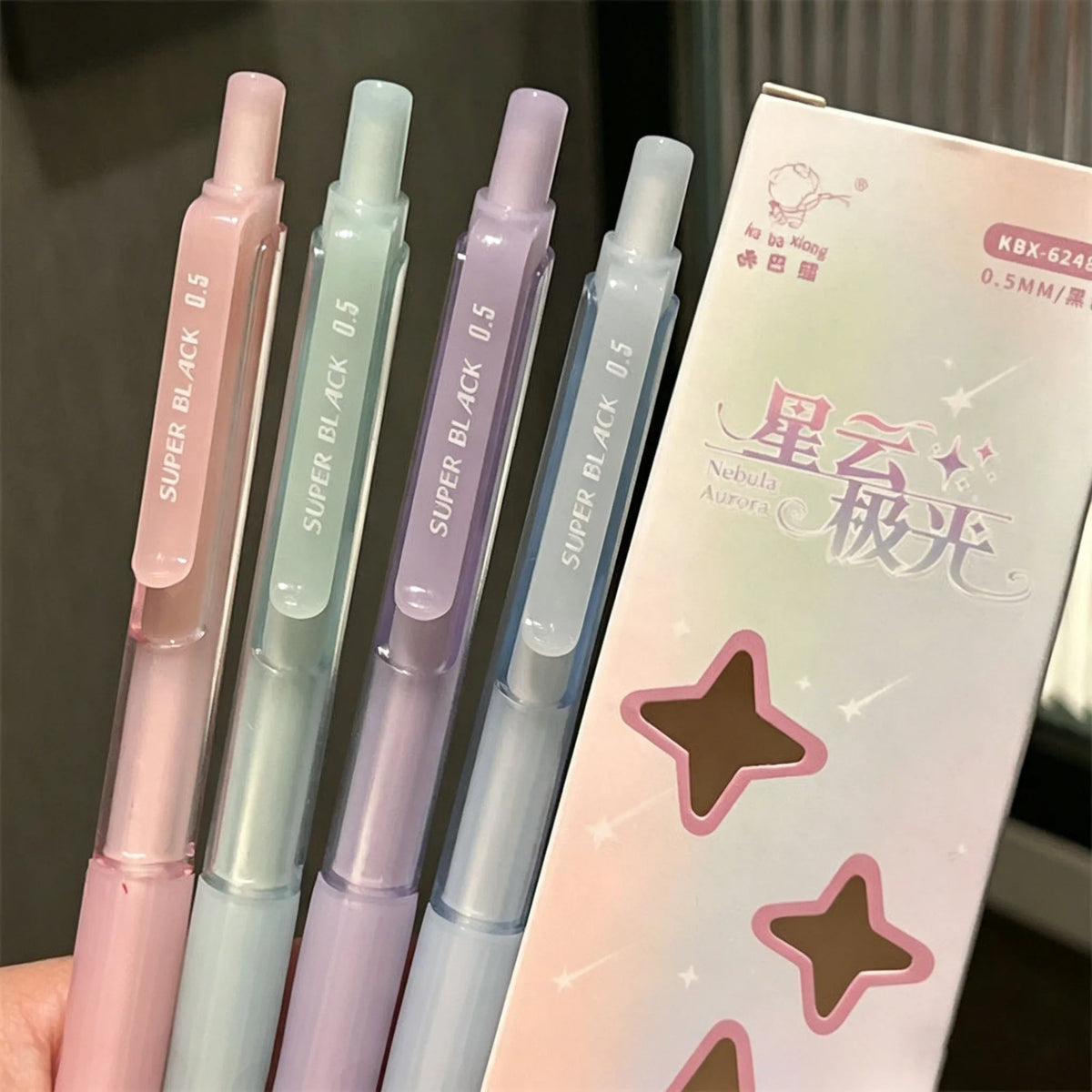 A pack of four pastel gradient gel pens with black ink, featuring pink, mint green, purple, and blue shades.