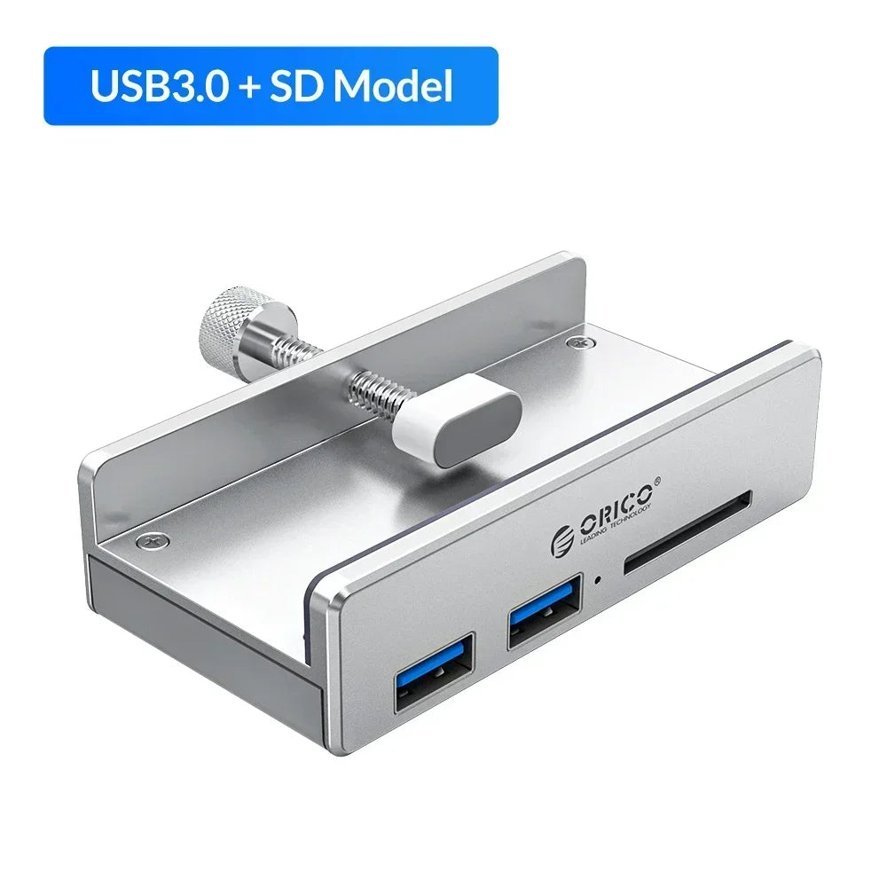 A silver multi-port USB 3.0 hub with a clip, featuring two blue ports and a silver adjustment mechanism.
