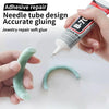A hand applies a clear, tube-shaped adhesive glue to a curved piece of jewelry.