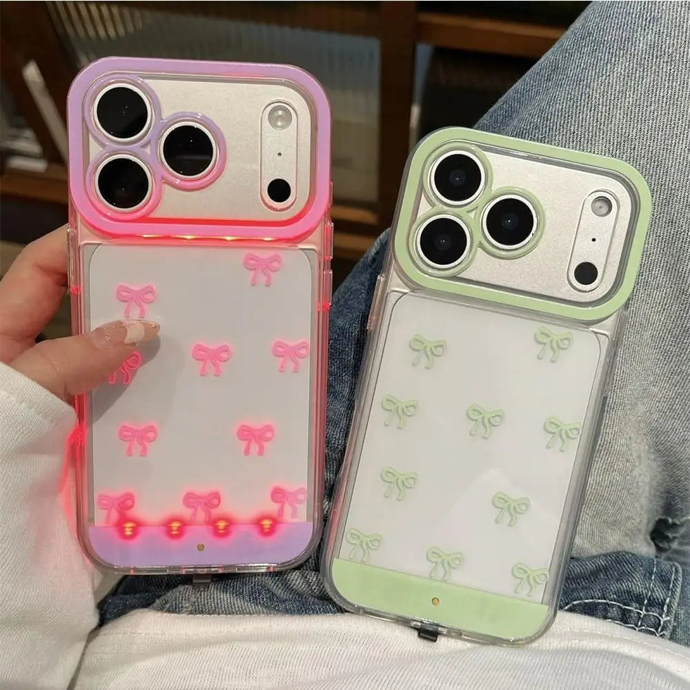 A pink LED bowknot glow case for an iPhone 17 Pro or Pro Max is shown in a light green color.