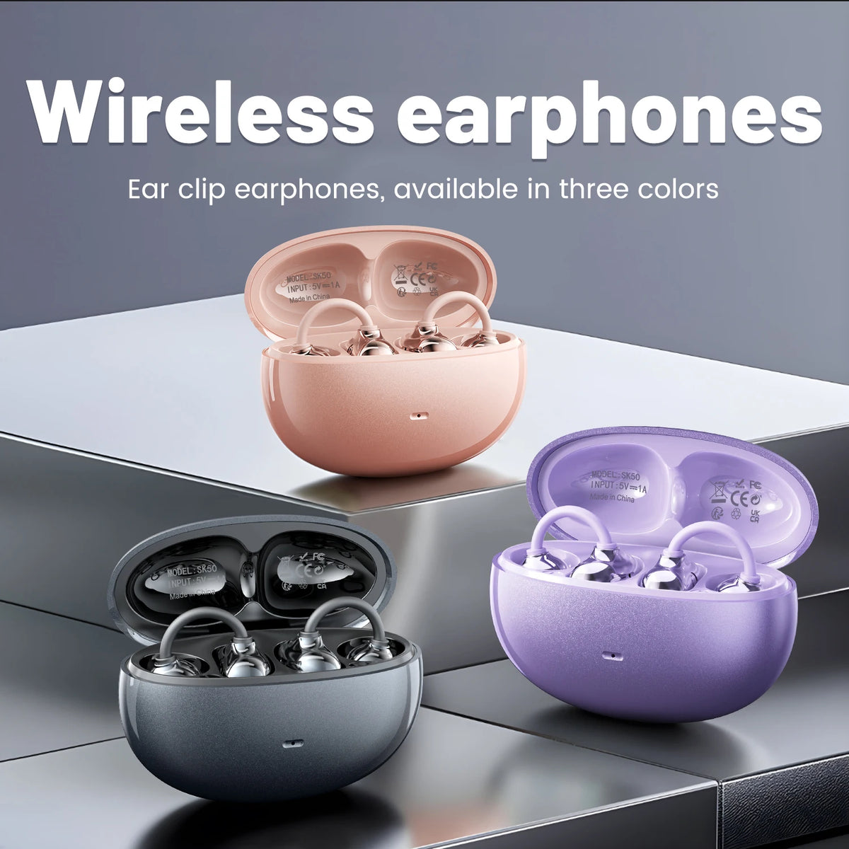 Three wireless earphones in pink, purple, and silver colors displayed with their charging cases.