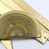 A brass drafting set with a graduated arc and ruler shown against a white background.