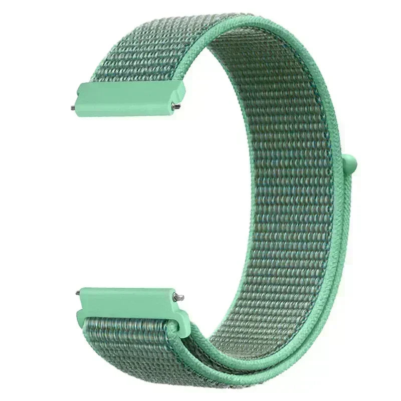 A close-up view of a mint green nylon loop watch strap for kids.