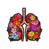 An enamel pin depicting a stylized human lung with colorful floral designs.