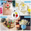 A collection of handmade gift bags, a postcard, and a flower bottle with a smiling face design.
