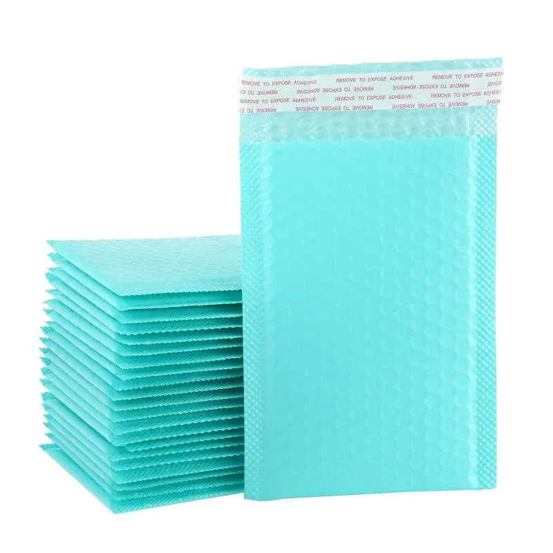 A stack of light turquoise pink bubble mailers with adhesive strips is shown.