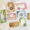 A collection of vintage paper craft elements including textured papers, lace, stamps, and decorative elements for scrapbookin