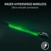 Razer HyperSpeed wireless mouse emitting a bright green light beam against a dark background.