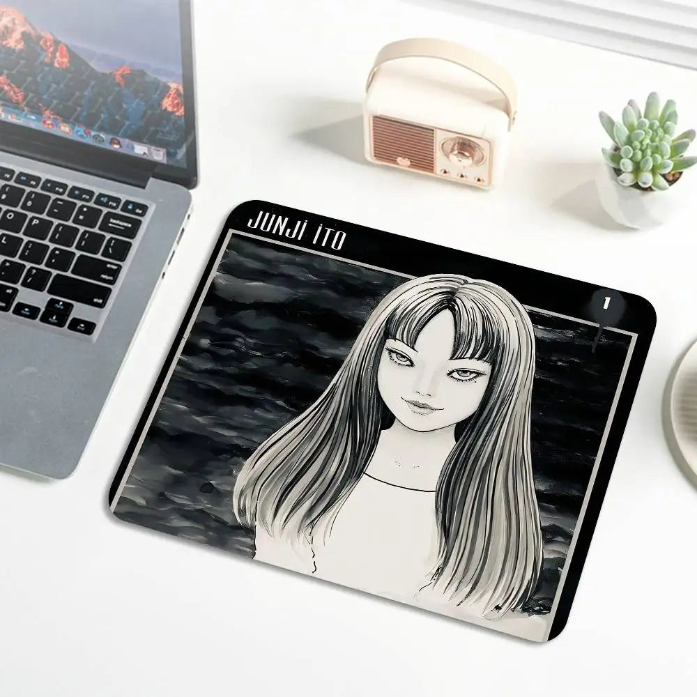 A black and white illustration of Junji Ito's Tomie featuring long hair on a mouse pad.
