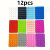 A set of 12 multi-pack silicone suction phone mounts in various colors including white, black, light blue, and pink.