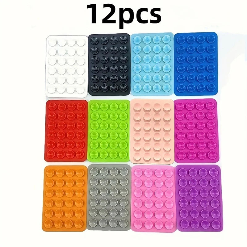 A set of 12 multi-pack silicone suction phone mounts in various colors including white, black, light blue, and pink.