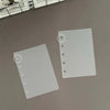A transparent divider page for a planner, showing a perforated edge.