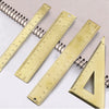 A set of brass drafting tools including rulers and a triangle for precision drawing.