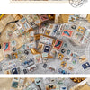 A collection of vintage stamp tape stickers and small paper stamps for scrapbooking