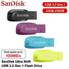 Three SanDisk USB 3.2 Gen 1 flash drives in black, purple, and blue colors.