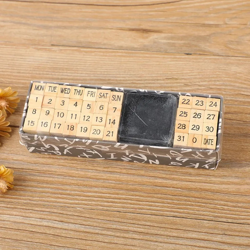 A rectangular wooden stamp seal set with numbered days and a dark square, placed on a light wooden surface.