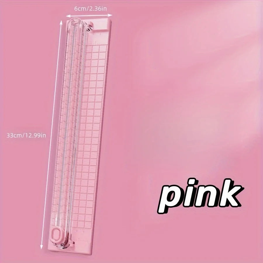 A pink portable manual paper cutter trimmer with a 6cm blade visible against a pink background.