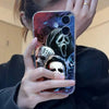 A hand holds an iPhone case featuring a dark, menacing mask design inspired by Michael Myers for Halloween.