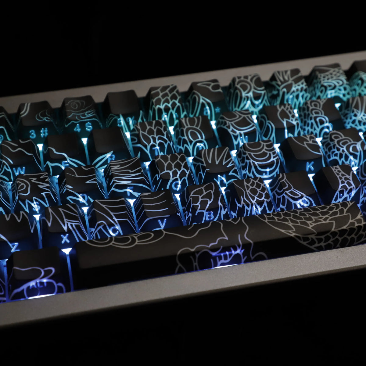 Close-up of blue side-lit PBT keycaps with intricate dragon designs on a keyboard layout.