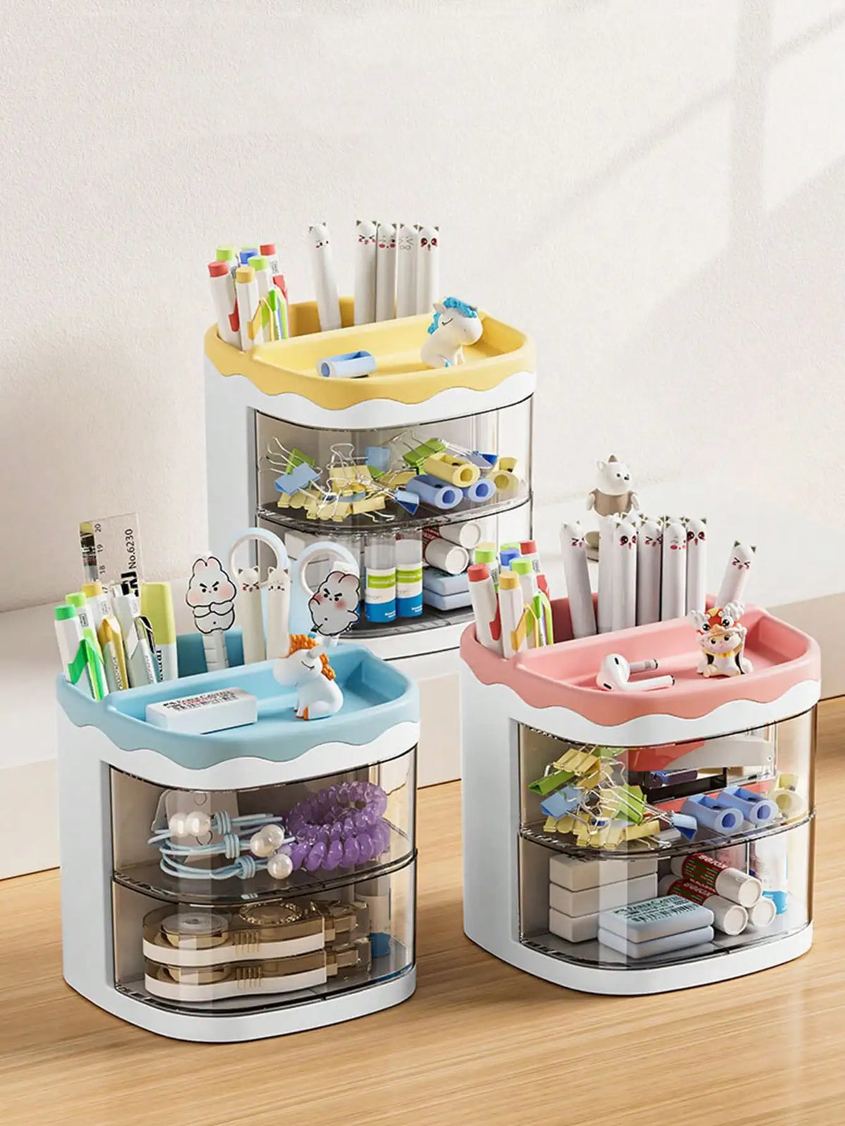 A set of white desktop pen holders with colorful accents and animal figures for office or school use.