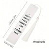A white rectangular bookmark with black text and a tassel on a thin cord.