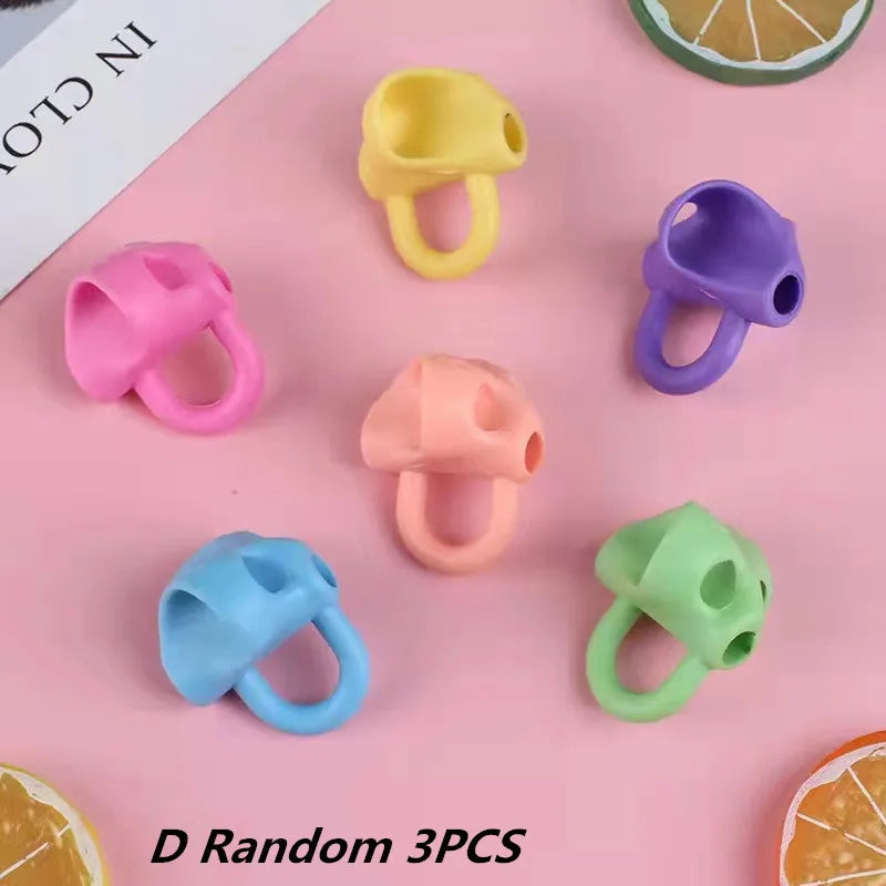 A collection of five colorful silicone pencil grips in yellow, pink, purple, orange, and green.