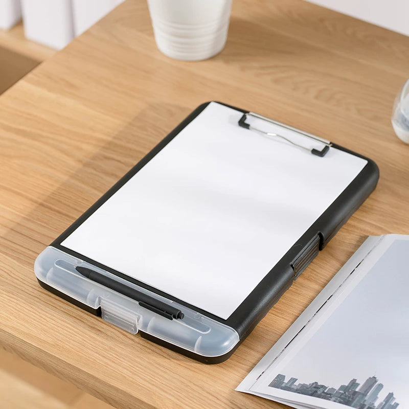 A black A4 waterproof file box with a writing board and pen slot resting on a wooden table.