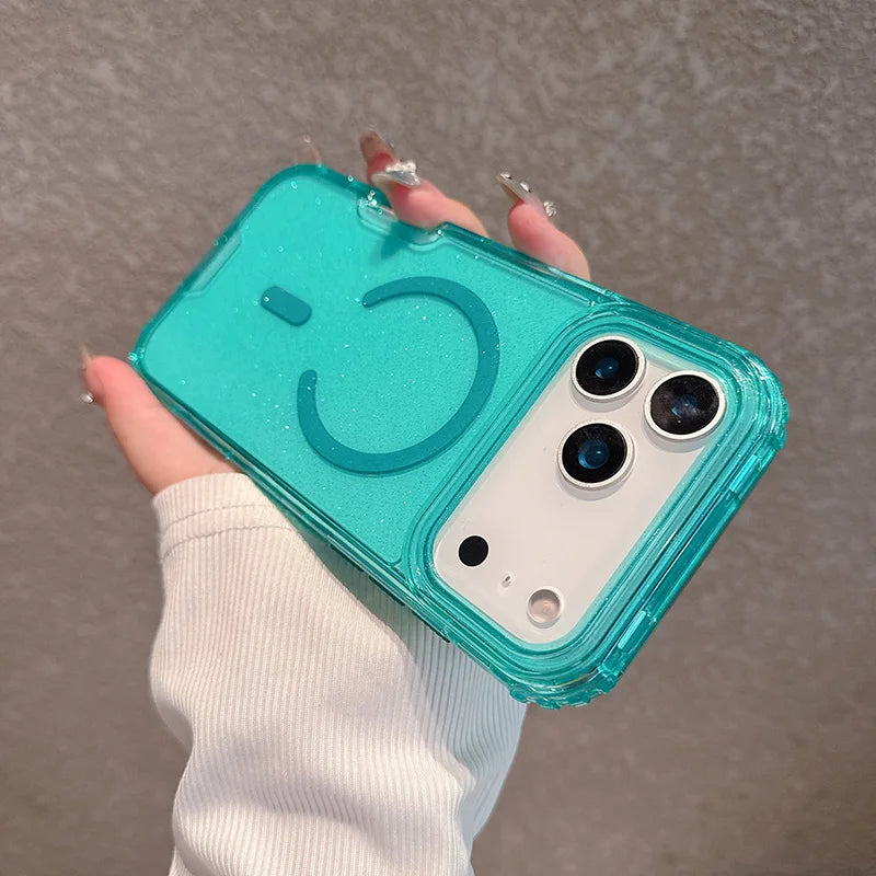 A hand holds a teal glitter shockproof magnetic case with a clear back and multiple camera lenses for an iPhone.