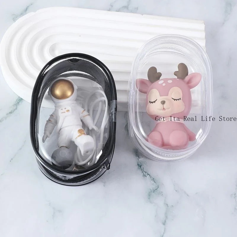 A small pink animal figurine is displayed inside a clear plastic bag on a marble surface.