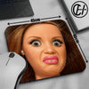A close-up of a mouse pad featuring a cute doll face design with long eyelashes and pink lips.