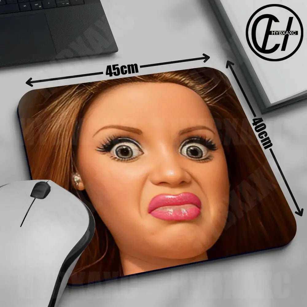 A close-up of a mouse pad featuring a cute doll face design with long eyelashes and pink lips.