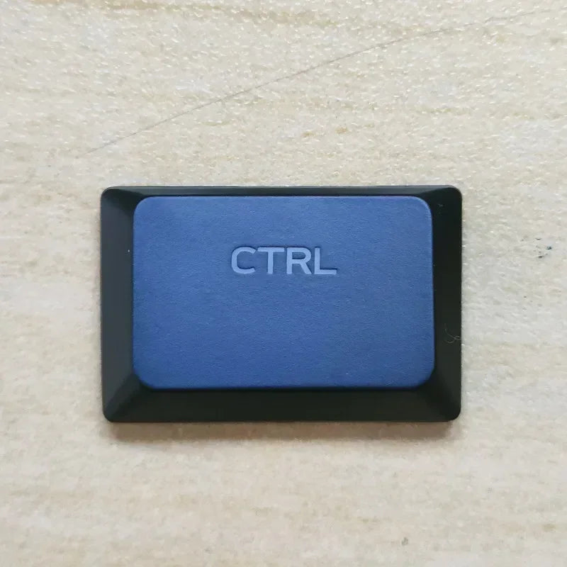 A close-up photo of a blue Ctrl keycap on a keyboard.