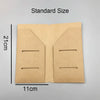 A tan, folded notebook shell with two horizontal slots is shown next to a measurement scale.